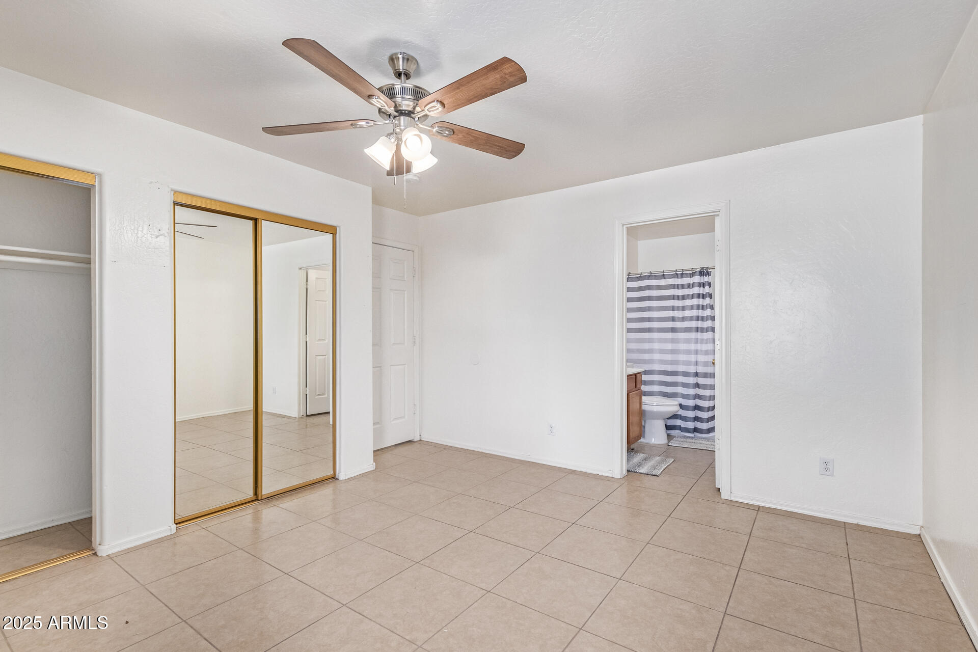 2118 West Adams Street Phoenix, AZ 85009 - Photo 13 of 48 an empty room with closet and windows