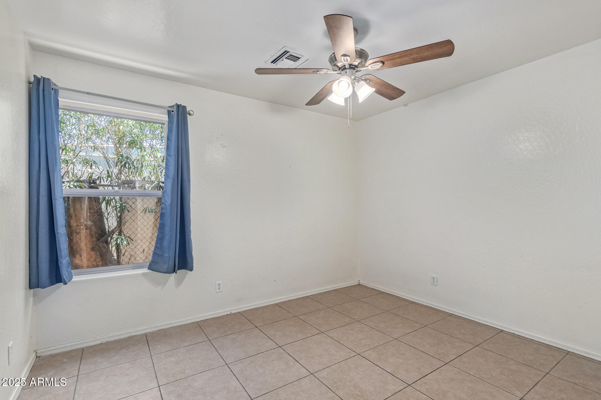 2118 West Adams Street Phoenix, AZ 85009 - Photo 15 of 48 a view of an empty room with a window