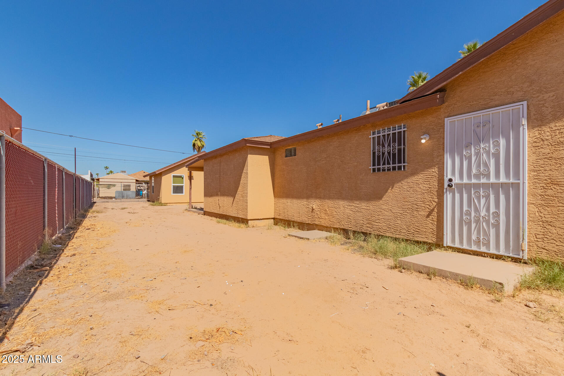 2118 West Adams Street Phoenix, AZ 85009 - Photo 25 of 48 a backyard of a house with a garage