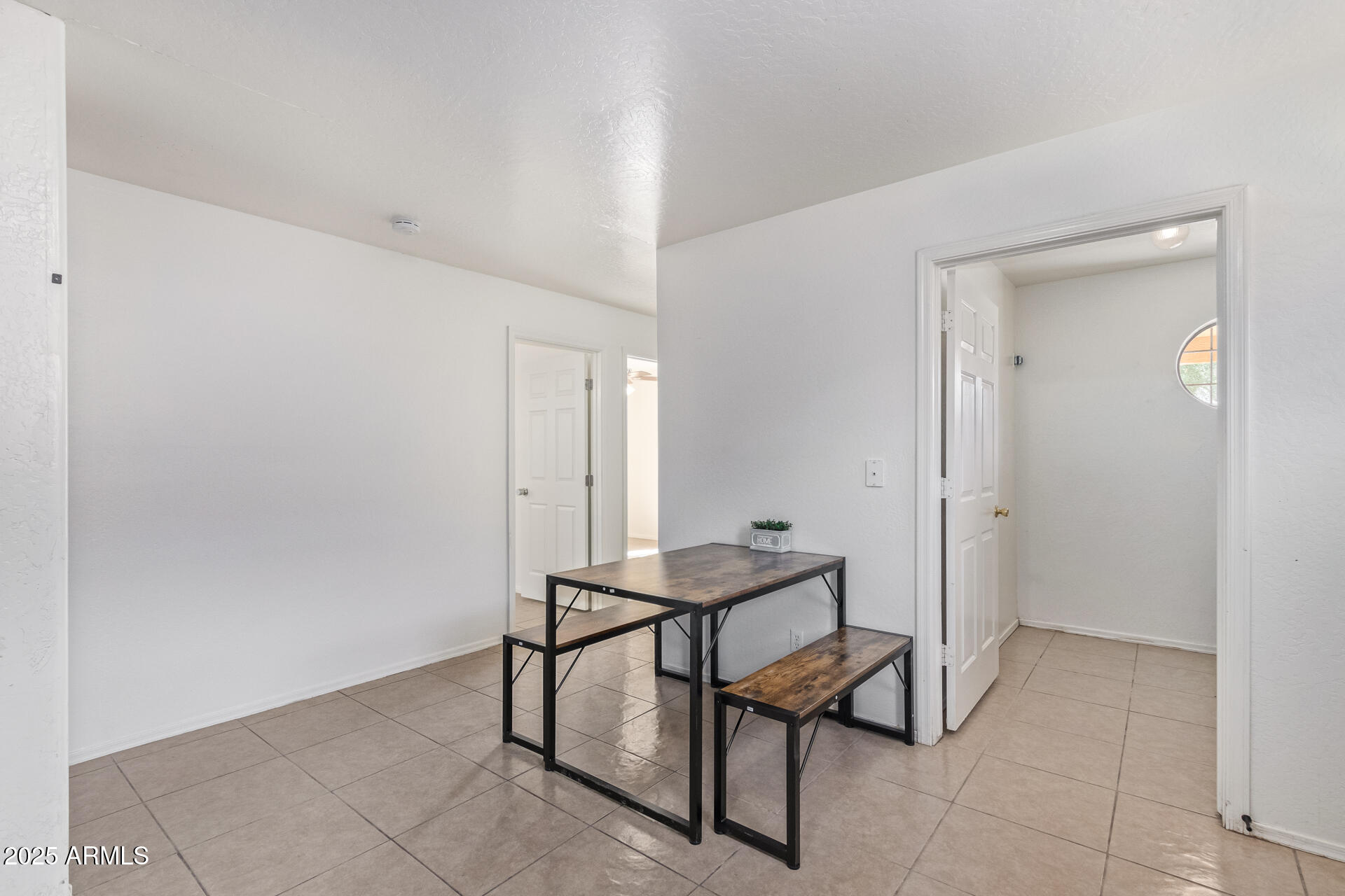 2118 West Adams Street Phoenix, AZ 85009 - Photo 7 of 48 a room that has a wooden table and chair in it