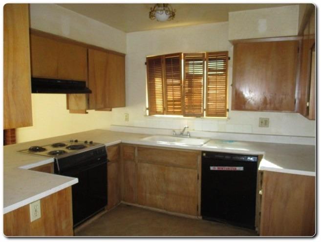 40367 Redbud Drive Oakhurst, CA 93644 - Photo 2 of 15 a kitchen with a sink stove and cabinets
