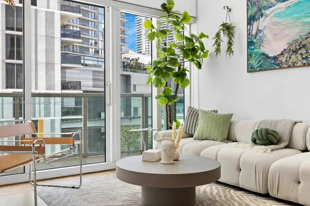 a living room with furniture and a potted plant