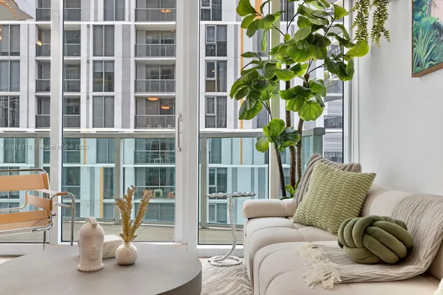 a living room with furniture flowerpot and window