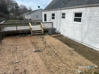 a view of a house with backyard and wooden fence