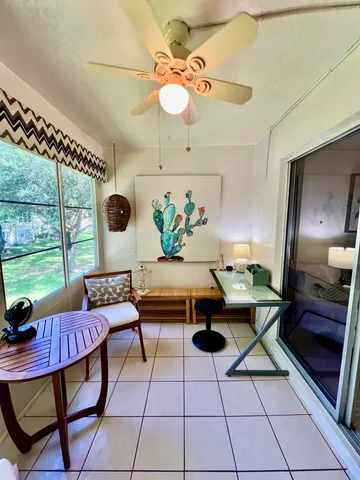a living room with furniture and a floor to ceiling window