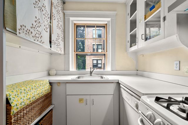 a kitchen with a sink stove and cabinets