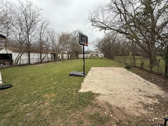 a view of a backyard with a garden and entertaining space