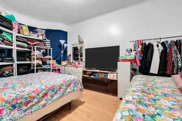 a bedroom with bed and a tv