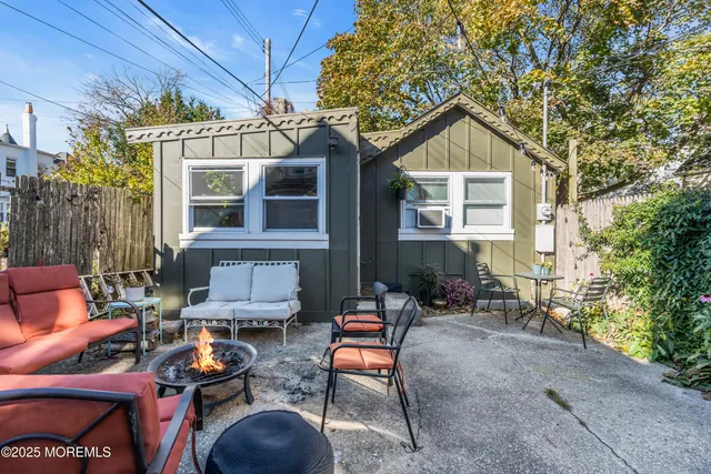 a view of a house with backyard and sitting area