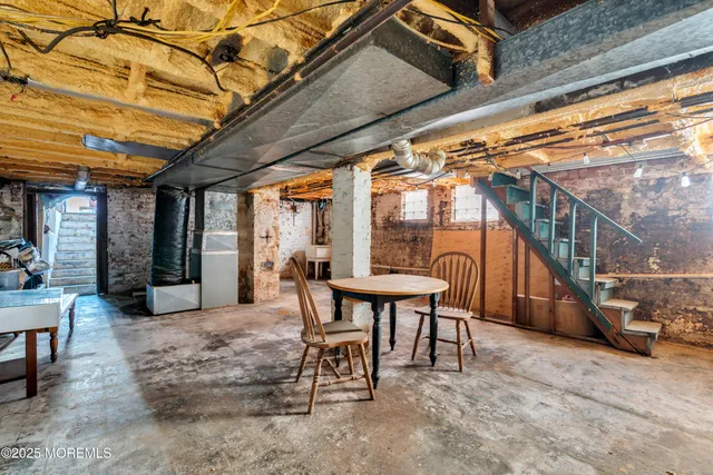 a backyard of a house with fire pit and outdoor seating