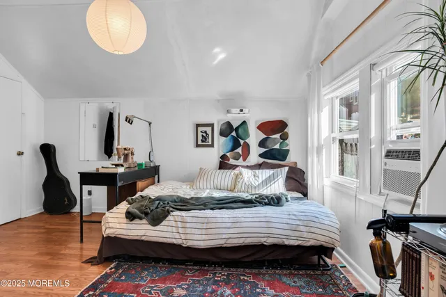 a bedroom with furniture and a window