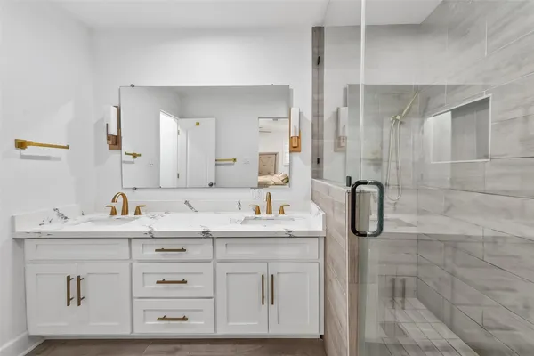 a bedroom with a bed and a flat tv screen on dresser