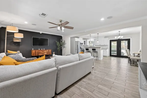 a living room with furniture and a chandelier