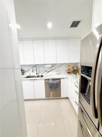 a kitchen with a sink a stove and cabinets