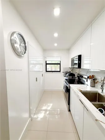 a kitchen with a refrigerator and a sink