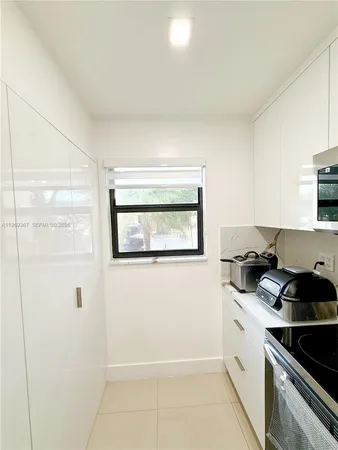 a kitchen with stainless steel appliances a refrigerator and a stove