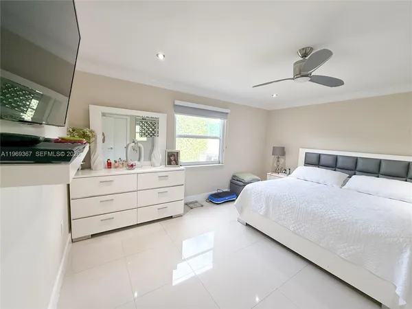 a bedroom with a bed and a large window