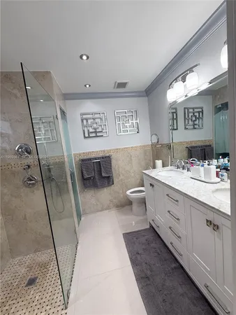 a bathroom with a double vanity sink and a mirror