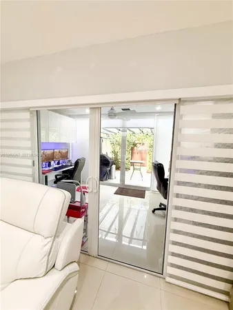 a living room with furniture and a floor to ceiling window