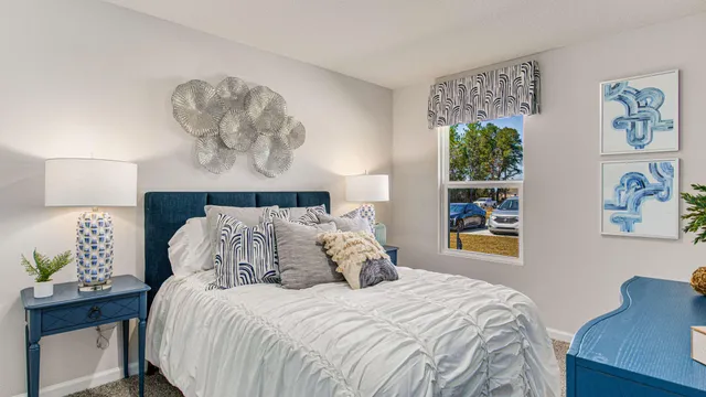 a bedroom with a bed and a potted plant