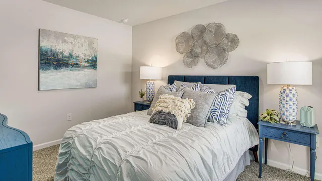 a bedroom with a bed and a potted plant
