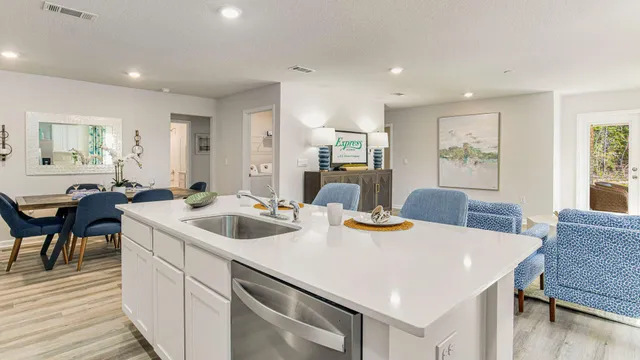 a kitchen with a stove a microwave a dining table and chairs