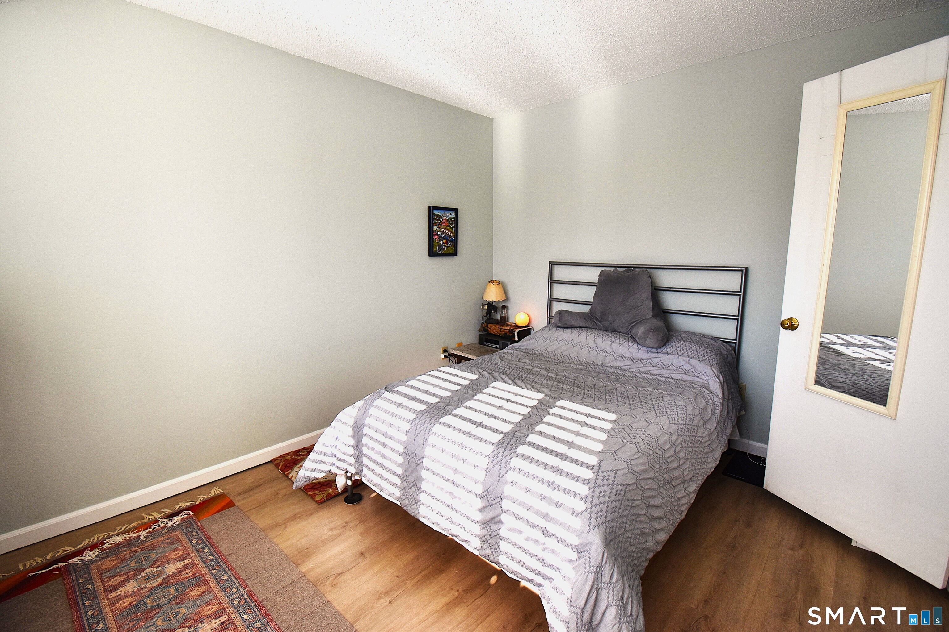 925 Oronoke Road, Unit 38A Waterbury, CT 06708 - Photo 23 of 29 a bedroom with a bed and wooden floor