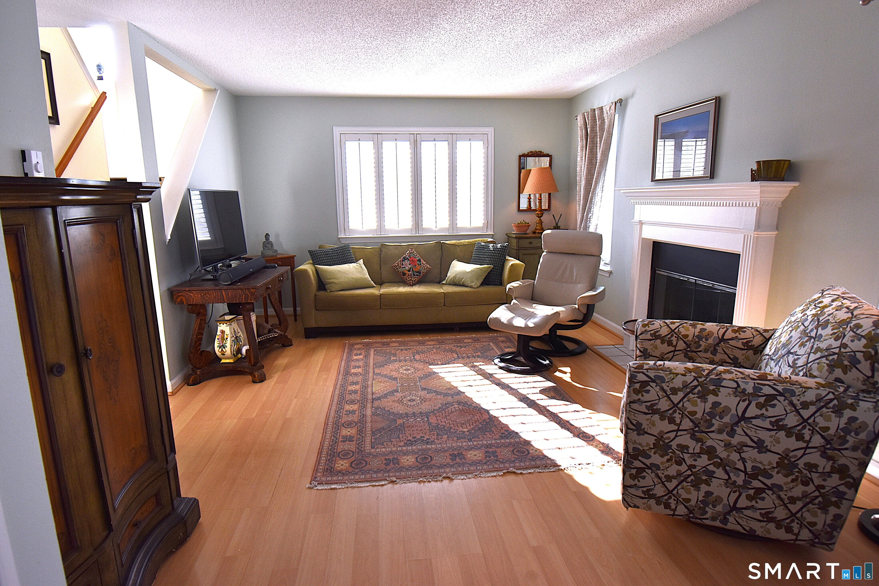 925 Oronoke Road, Unit 38A Waterbury, CT 06708 - Photo 29 of 29 a living room with furniture a fireplace and a flat screen tv