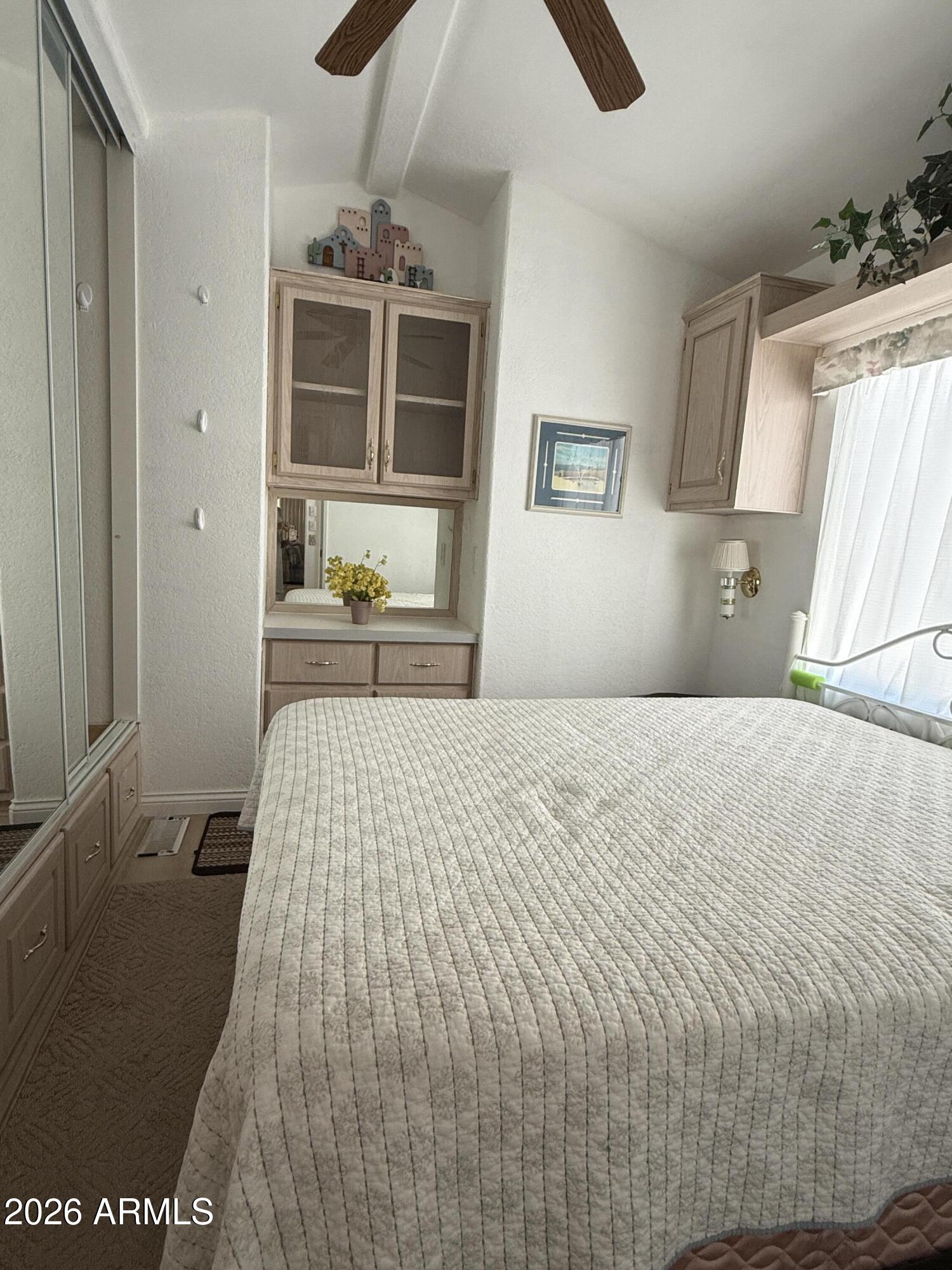 21340 Trading Post Trail Congress, AZ 85332 - Photo 14 of 31 a bedroom with a bed and a chandelier