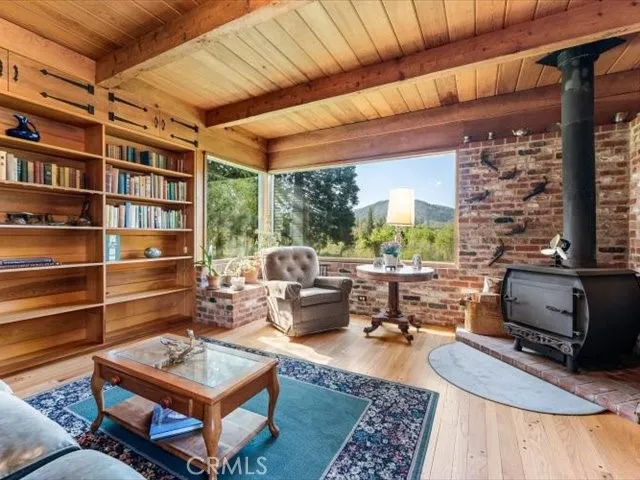 a living room with furniture a rug and a book shelf