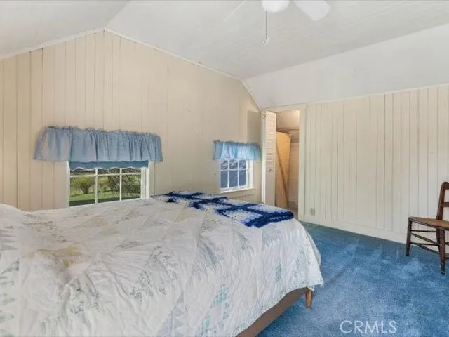 a bedroom with a bed windows and a bed