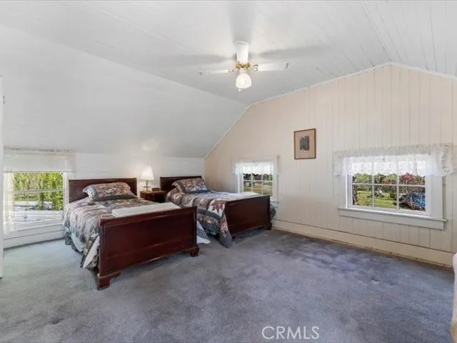 a spacious bedroom with a bed and a window