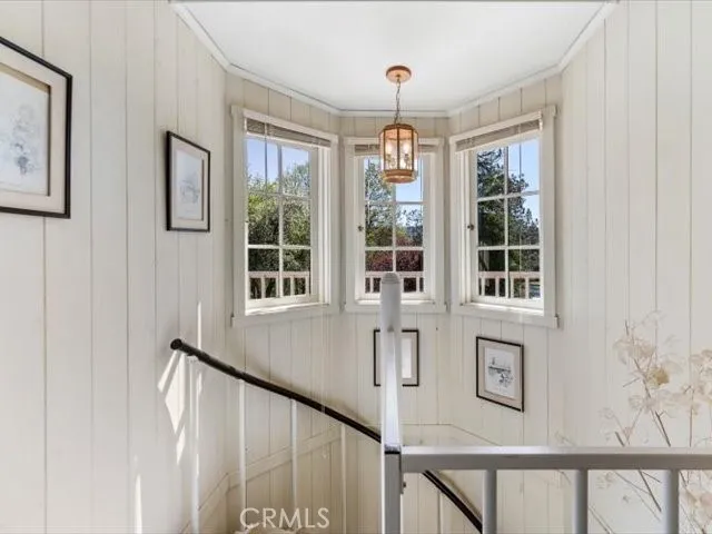 a living room with furniture a rug and a large window
