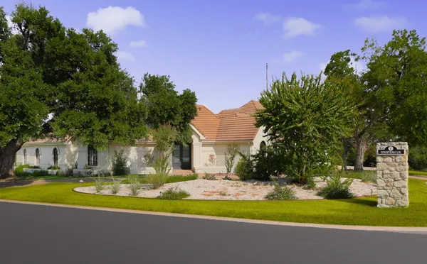 a view of a fountain in front of a house