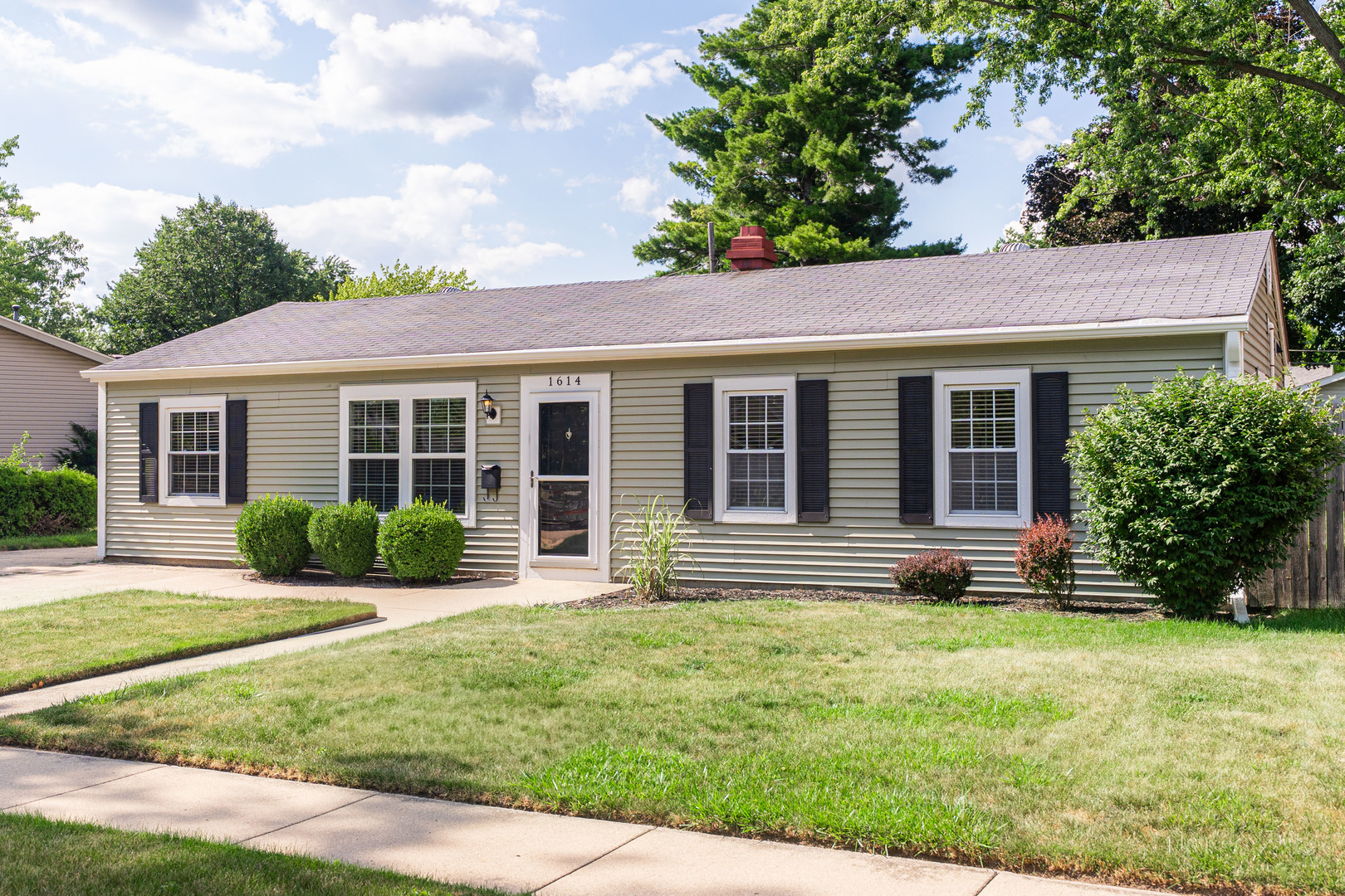 1614 East Dresser Road DeKalb, IL 60115 - Photo 1 of 26 a front view of a house with a yard and outdoor seating
