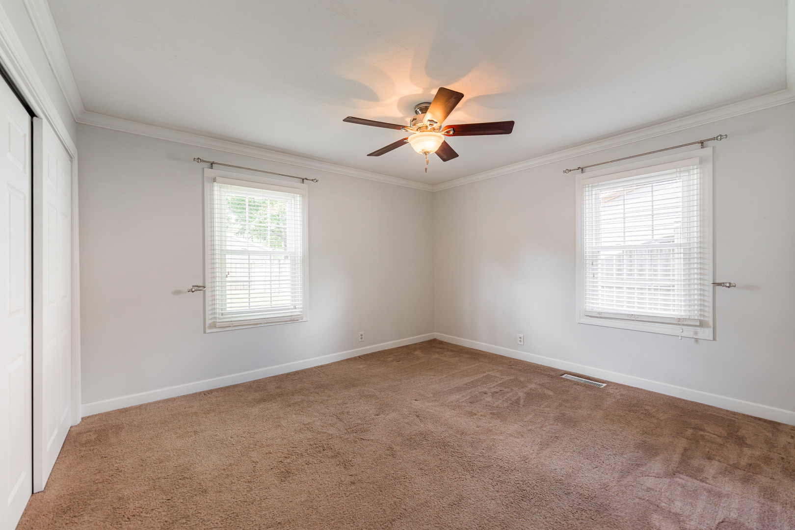 1614 East Dresser Road DeKalb, IL 60115 - Photo 12 of 26 an empty room with windows and fan