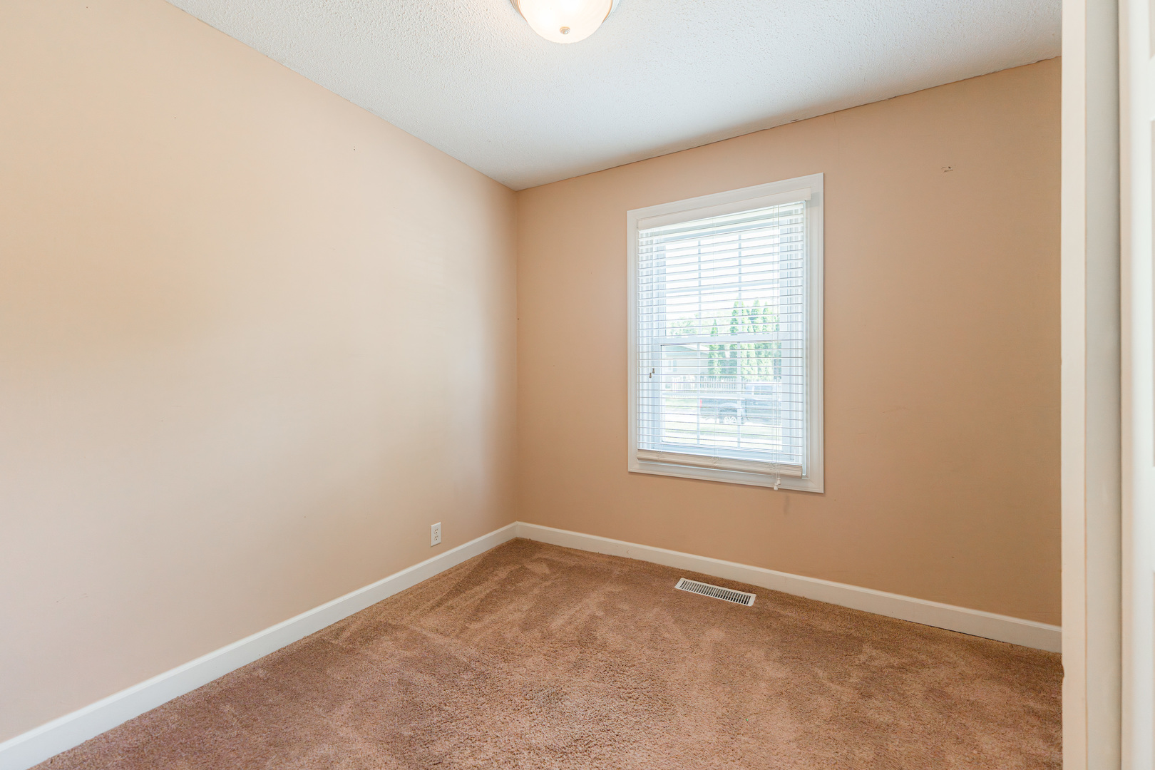 1614 East Dresser Road DeKalb, IL 60115 - Photo 16 of 26 an empty room with a window