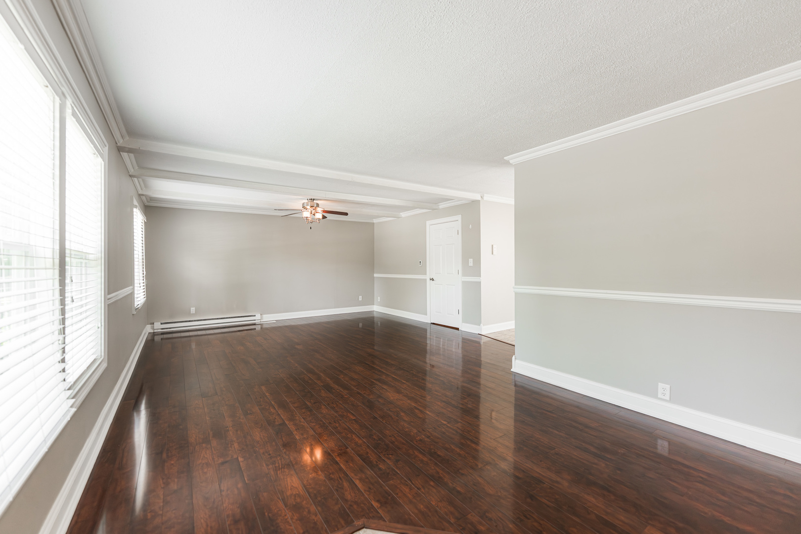 1614 East Dresser Road DeKalb, IL 60115 - Photo 2 of 26 an empty room with wooden floor and windows