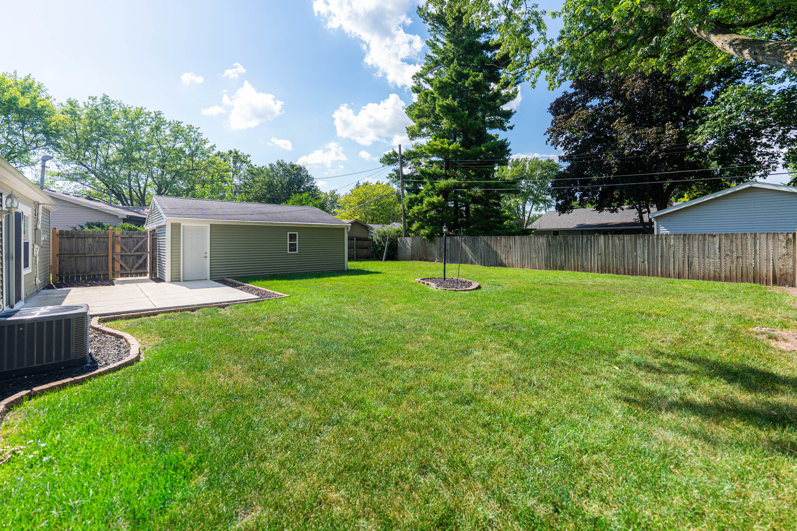 1614 East Dresser Road DeKalb, IL 60115 - Photo 22 of 26 a swimming pool with lots of tress in front of it