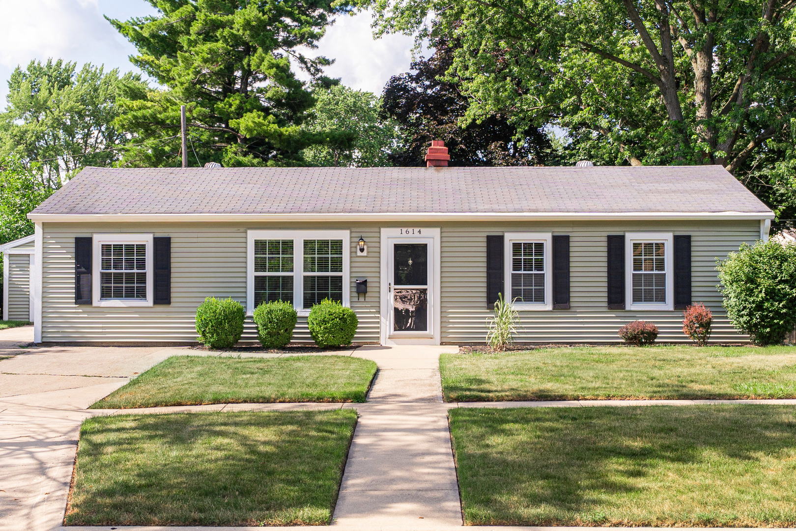 1614 East Dresser Road DeKalb, IL 60115 - Photo 26 of 26 a front view of a house with a yard table and chairs