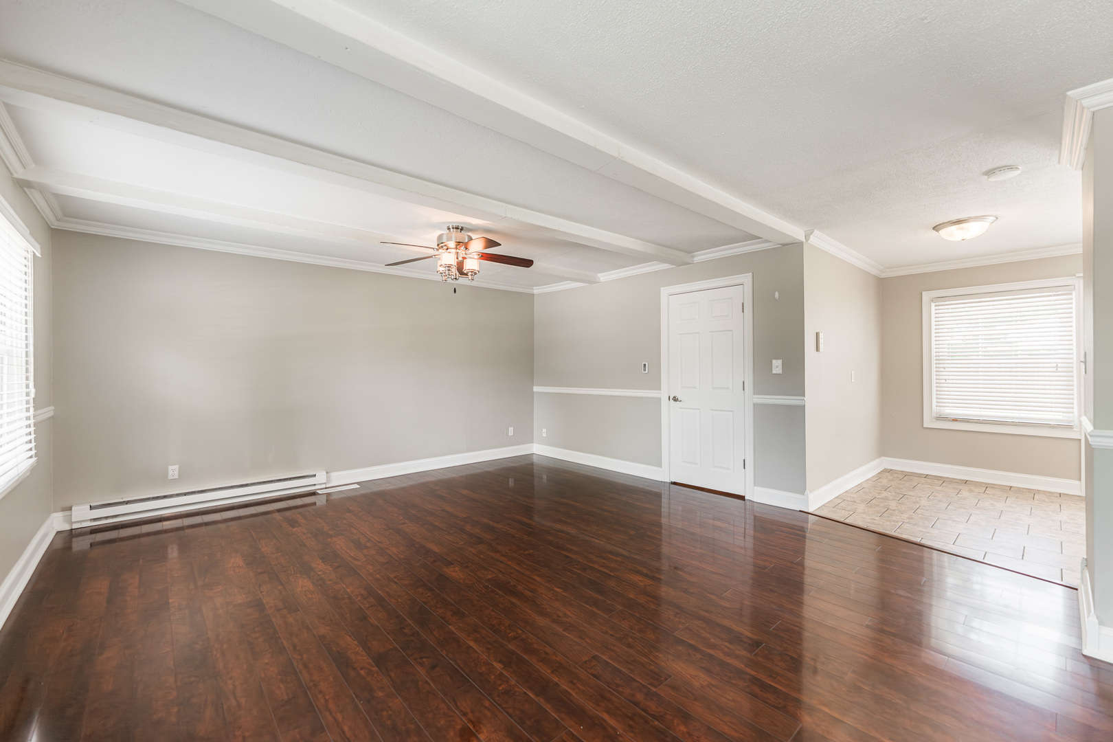 1614 East Dresser Road DeKalb, IL 60115 - Photo 3 of 26 an empty room with wooden floor & windows in it