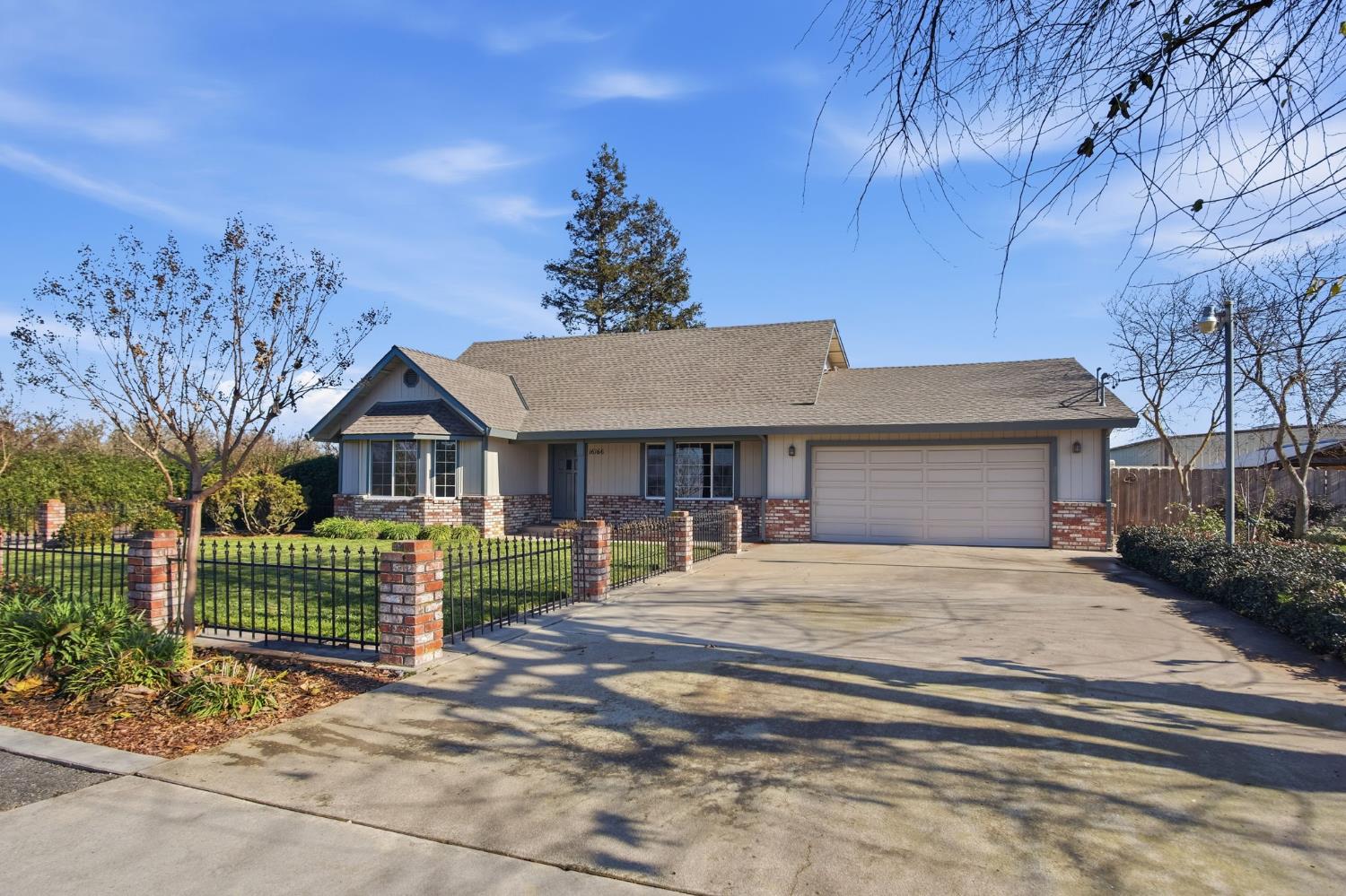 16166 Lawrence Road Escalon, CA 95320 - Photo 4 of 56 a front view of a house with a garden
