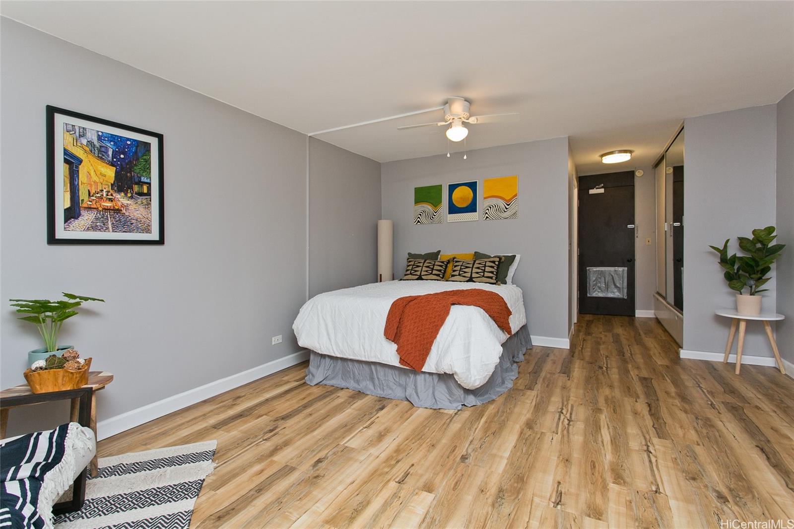 747 Amana Street, Unit 1113 Honolulu, HI 96814 - Photo 1 of 1 a bedroom with a bed and a chandelier