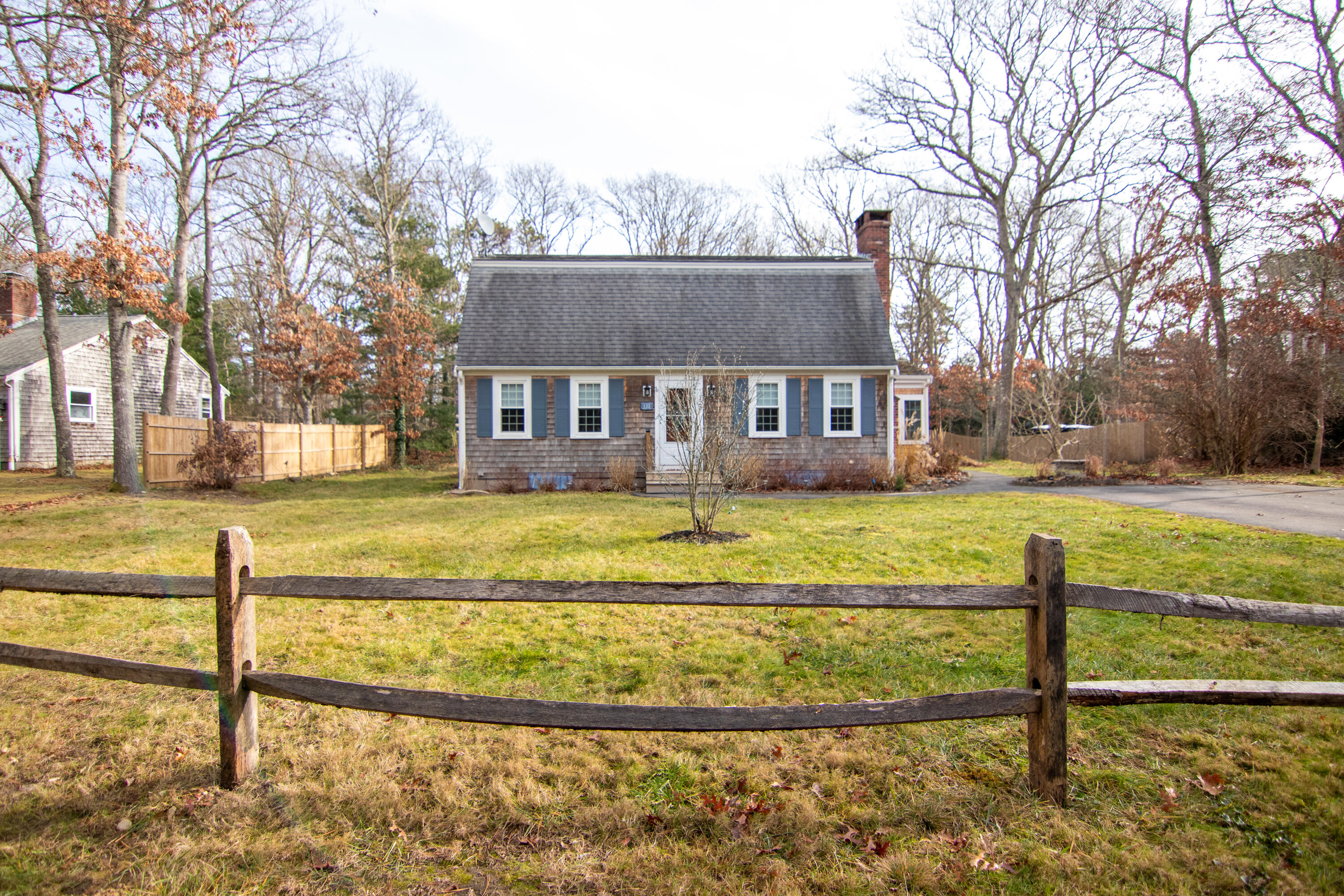 122 Skunknet Road Centerville, MA 02632 - Photo 58 of 61 a view of a house with a big yard and large trees