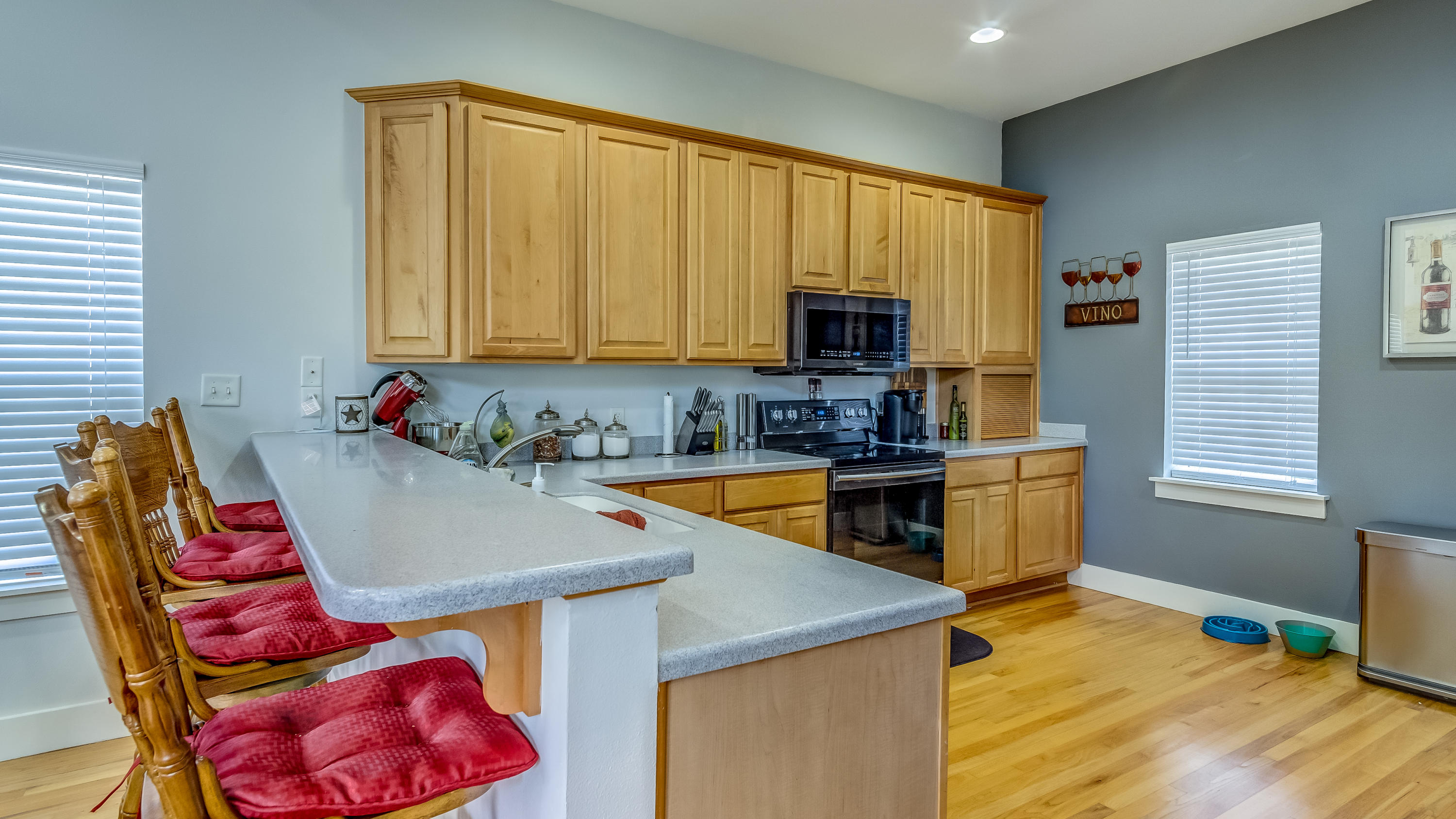 556 Mallet Bayou Road Freeport, FL 32439 - Photo 15 of 29 a kitchen with stainless steel appliances granite countertop a sink a stove top oven a dining table and chairs with wooden floor