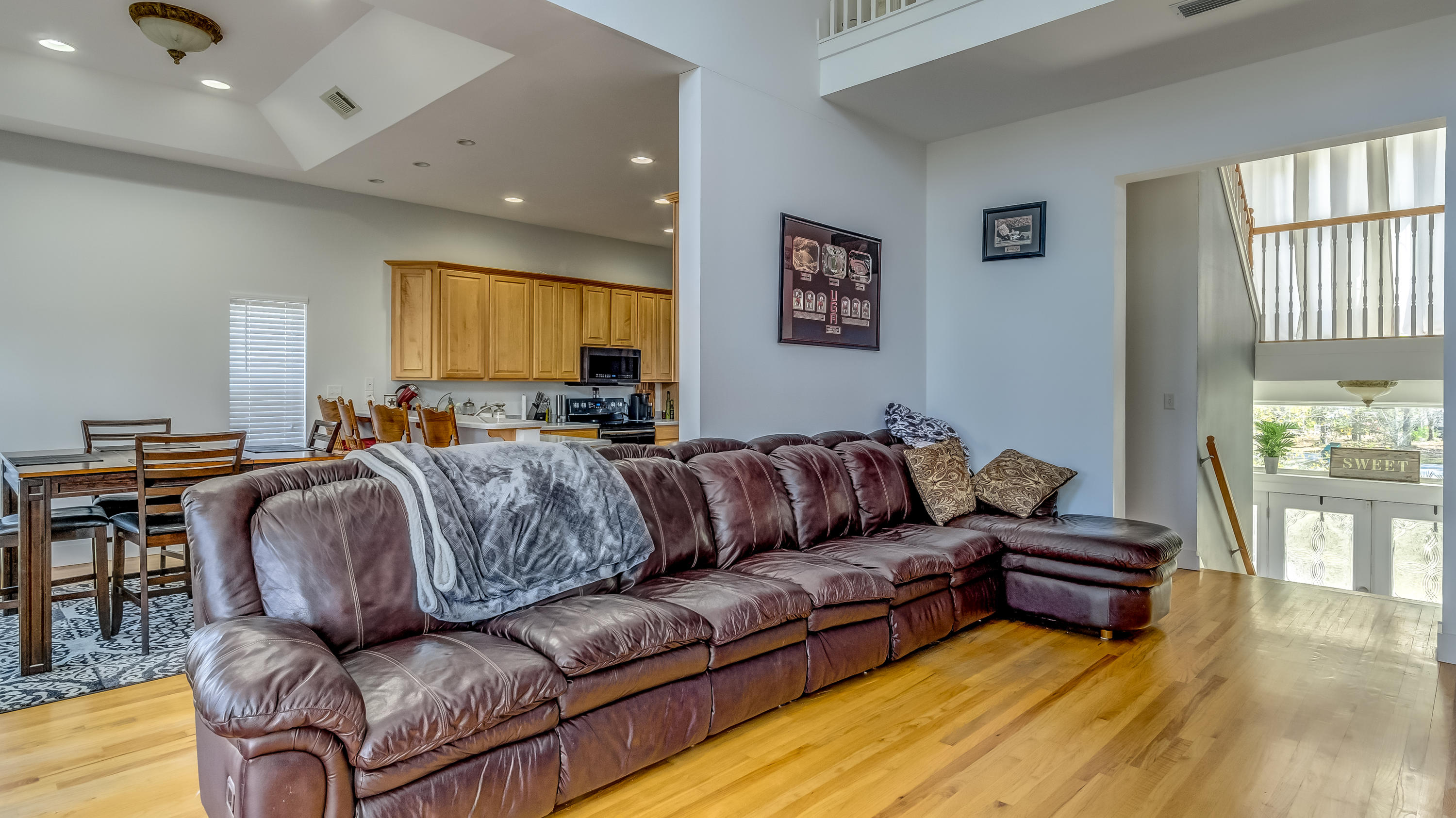556 Mallet Bayou Road Freeport, FL 32439 - Photo 18 of 29 a living room with couches a flat screen tv and kitchen view