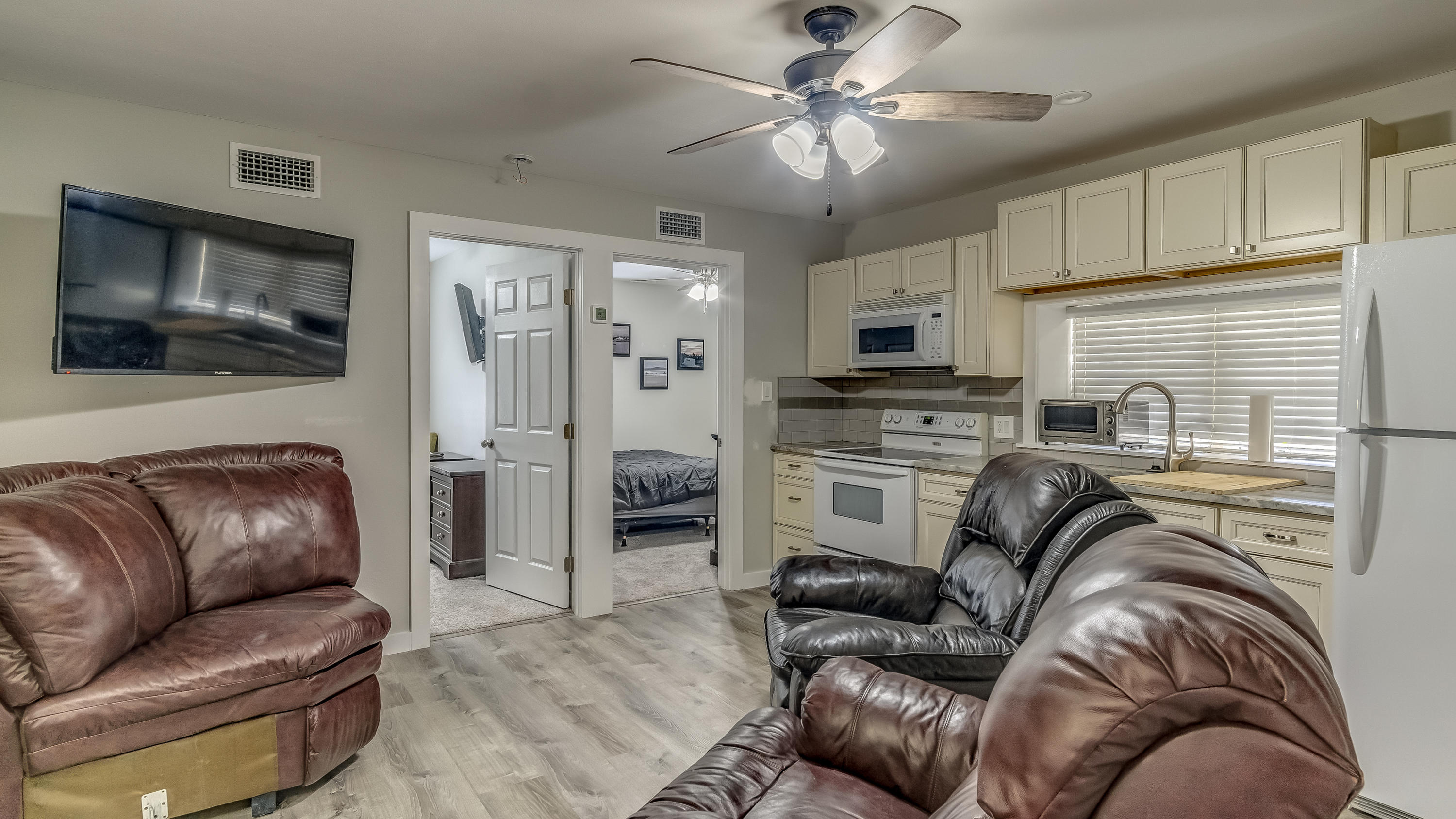 556 Mallet Bayou Road Freeport, FL 32439 - Photo 22 of 29 a living room with furniture ceiling fan and a flat screen tv
