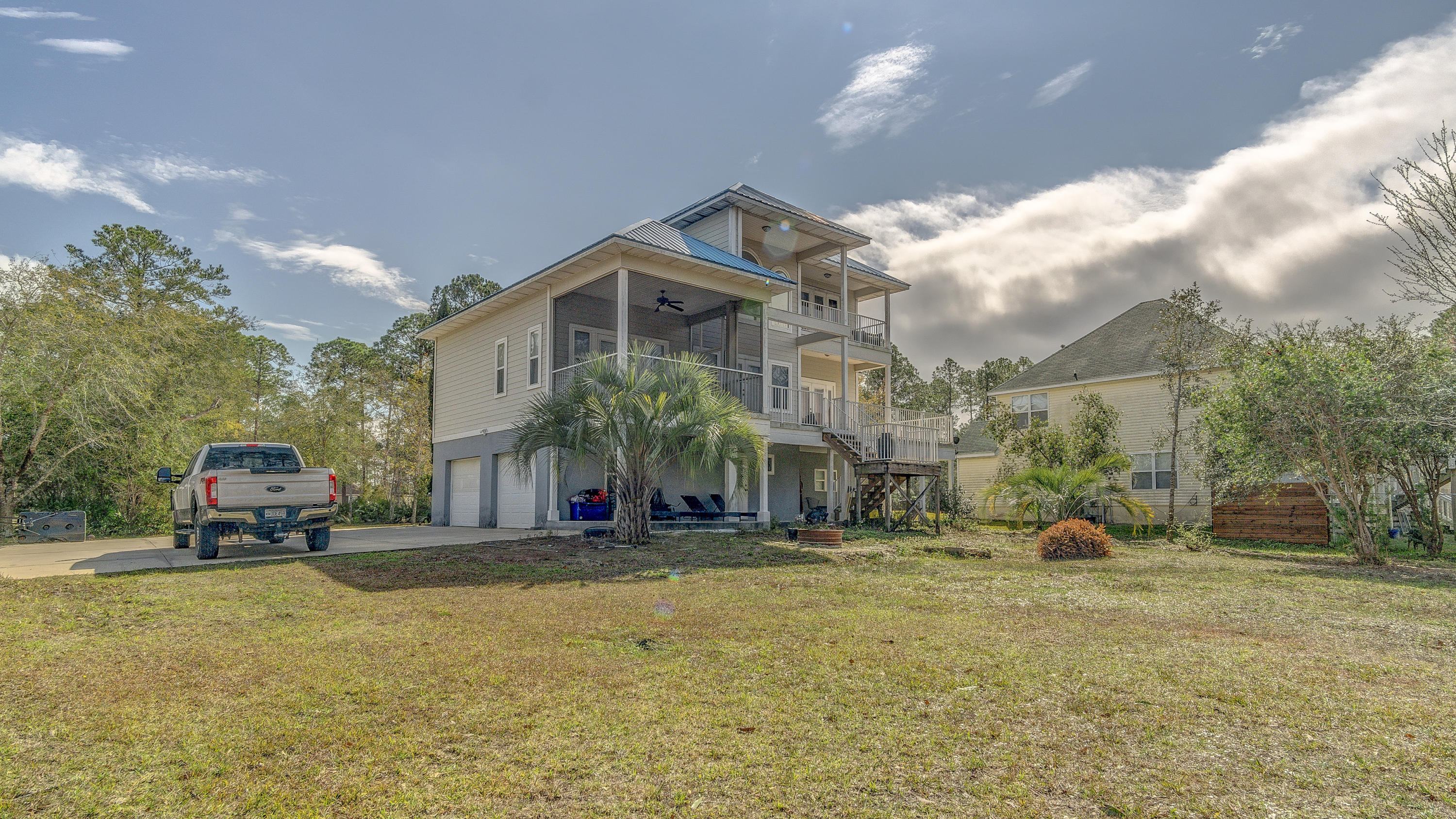 556 Mallet Bayou Road Freeport, FL 32439 - Photo 10 of 29 a view of a big house with cars parked in front of it