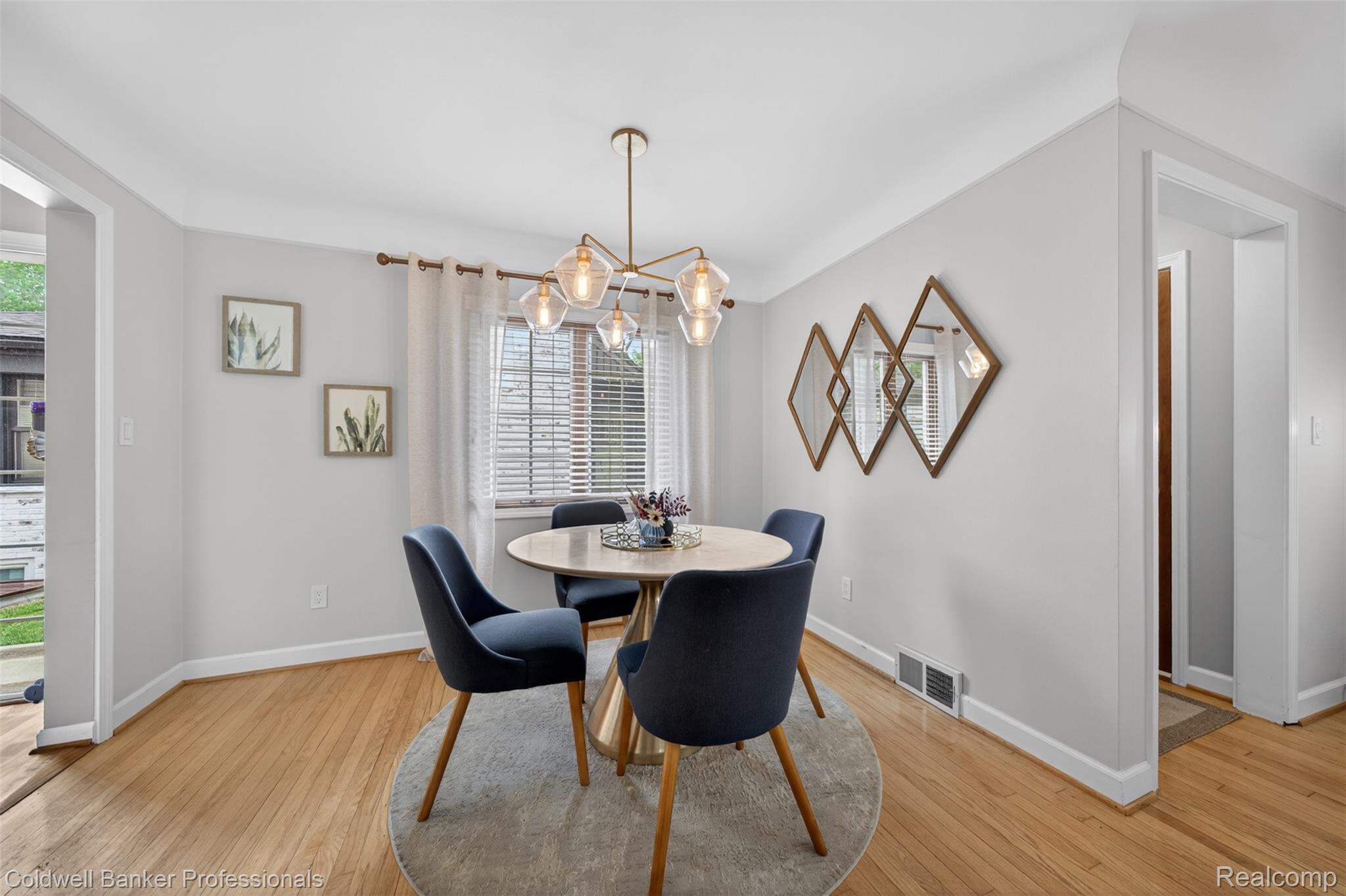 2666 Windemere Road Birmingham, MI 48009 - Photo 3 of 24 Hardwood flooring featured in this dining area with a modern chandelier and recessed window