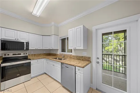 a kitchen with a stove a sink and a microwave